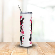 Tumbler with nail polish and high heel design on a wooden surface with a white background
