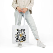 Person holding a tote bag with 'Wife of the Party' text and champagne graphic.