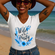 Woman on a beach wearing a white t-shirt with 'Wife of the Party' design.