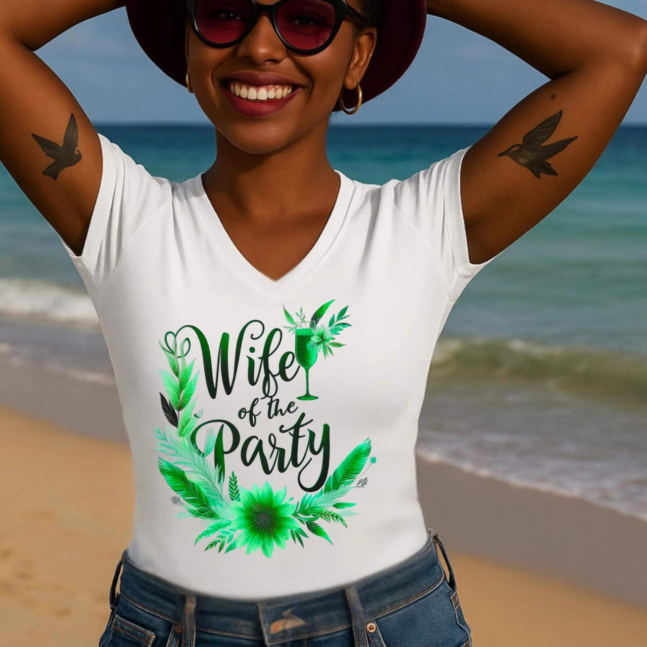 Woman wearing a white sleeveless shirt with 'Wife of the Party' design on a beach.