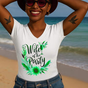 Woman wearing a white sleeveless shirt with 'Wife of the Party' design on a beach.