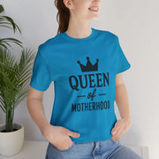 Person wearing a blue t-shirt with 'Queen of Motherhood' text and a crown graphic.