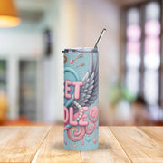 Tumbler with decorative design on a wooden table