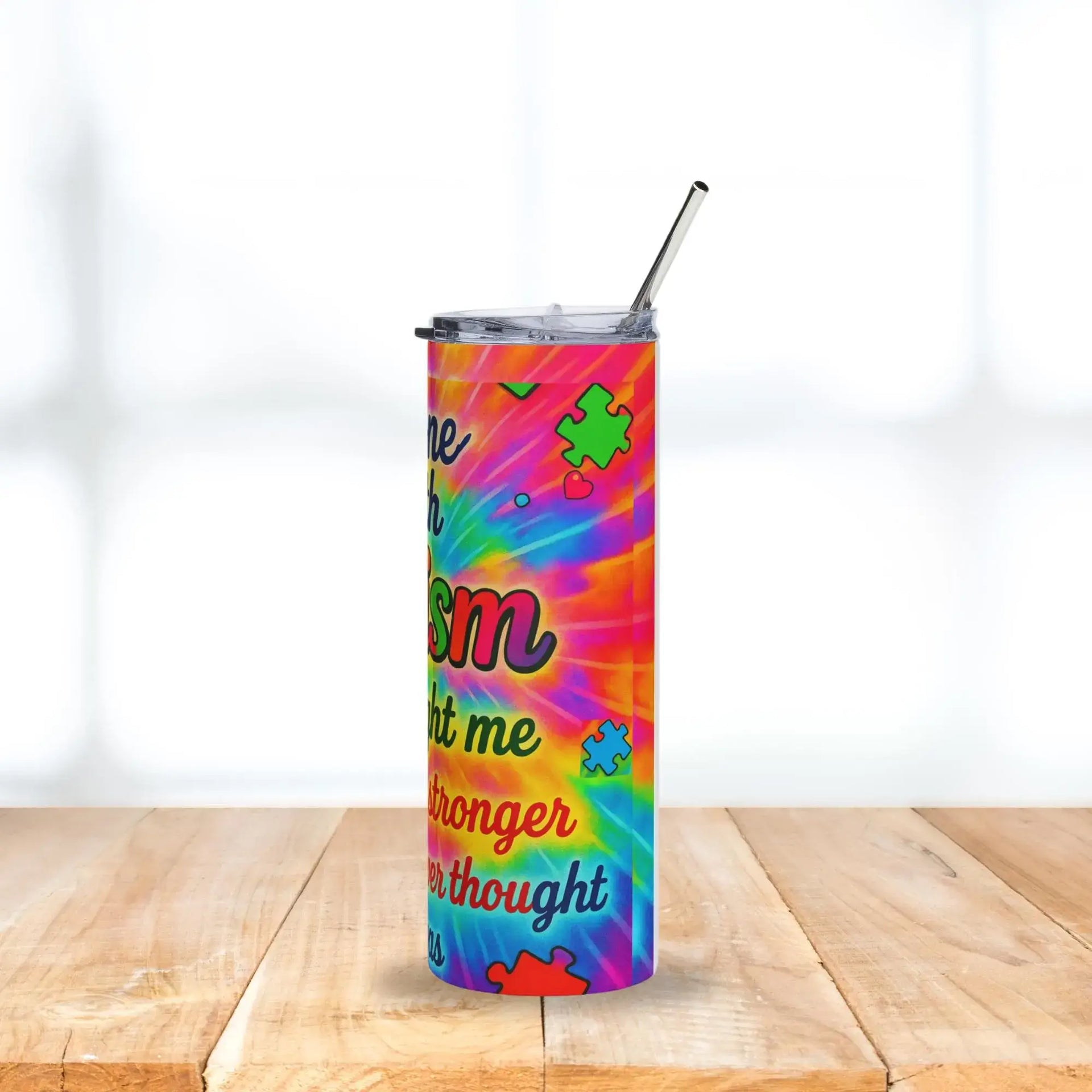 Colorful tumbler with text and patterns on a wooden surface