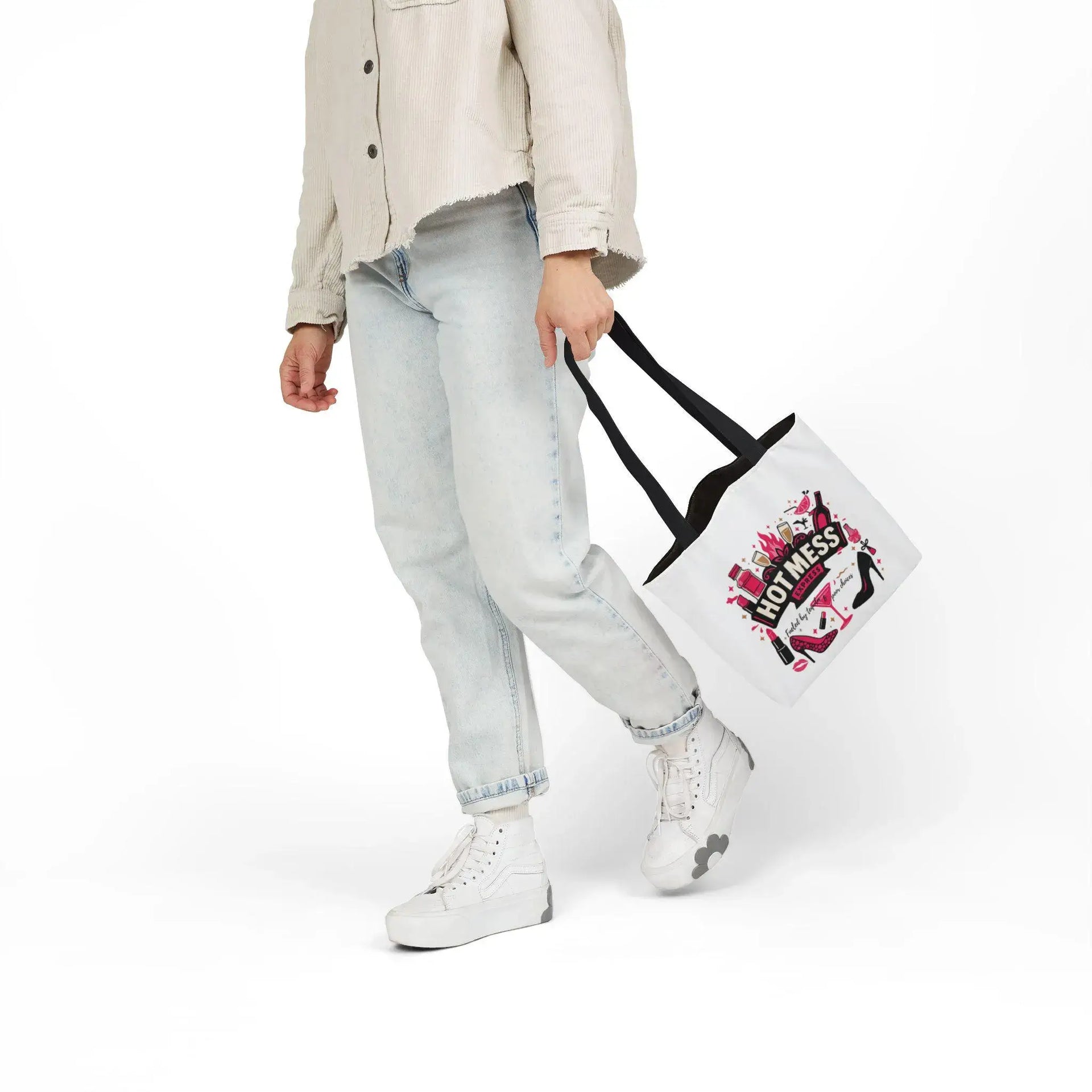 Person holding a tote bag with a graphic design on a white background