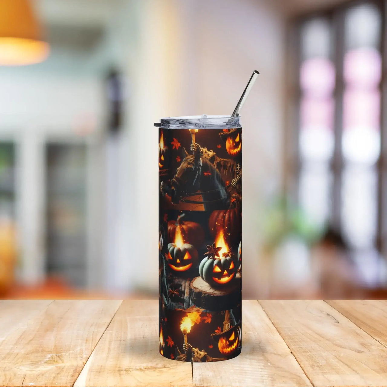Tumbler with Halloween design featuring pumpkins and ghosts on a wooden table.