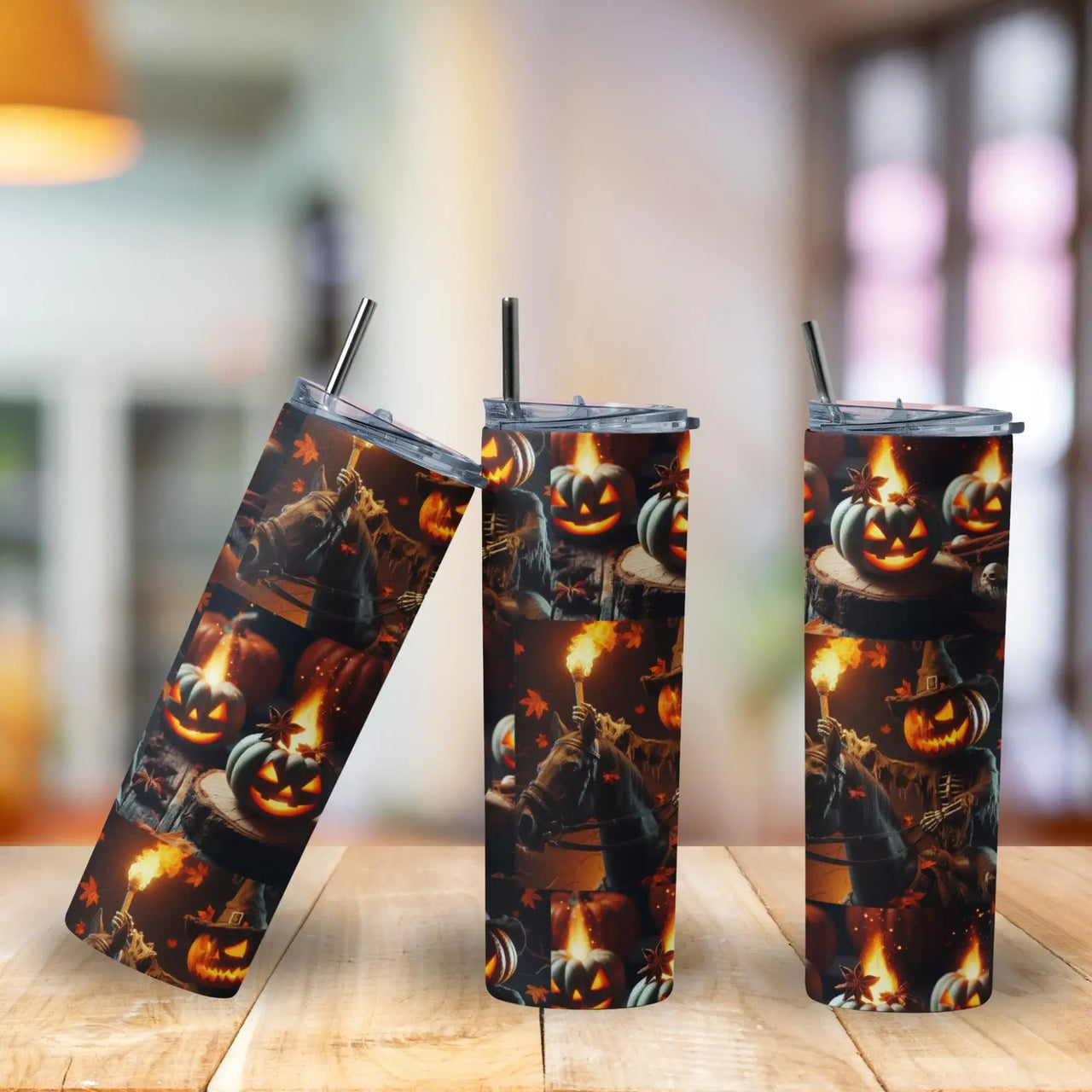 Three Halloween-themed tumblers with pumpkins and ghosts on a wooden surface.