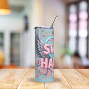 Tumbler with colorful design on a wooden table with a blurred background