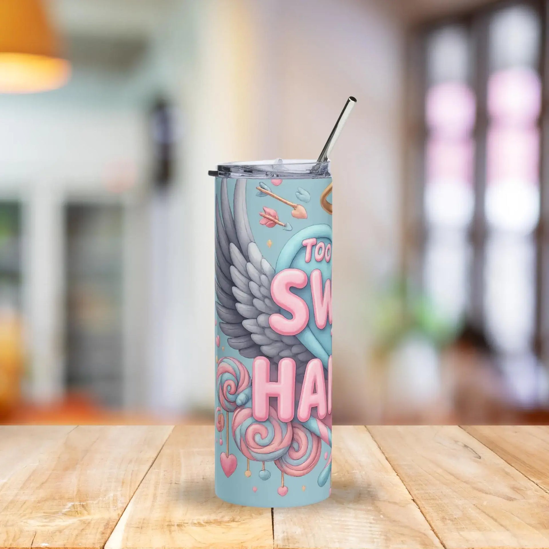 Tumbler with colorful design on a wooden table with a blurred background