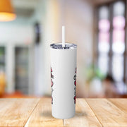 White tumbler with a straw on a wooden table in a blurred indoor setting