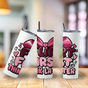 Three insulated tumblers with colorful designs on a wooden surface.
