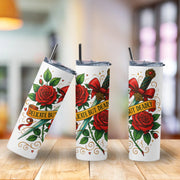Three white tumblers with red roses, green leaves, and decorative text on a wooden surface.