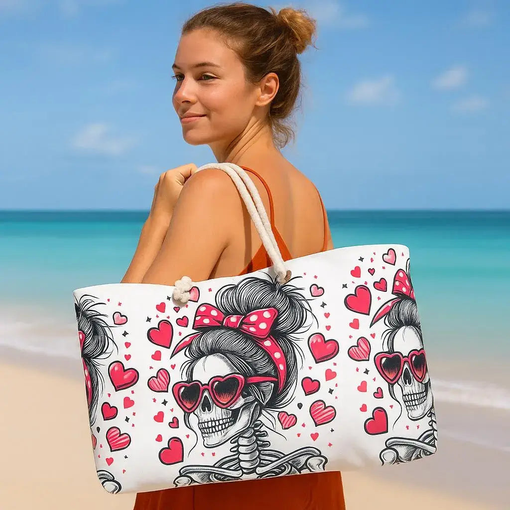 Woman holding a beach bag with skull and heart design on a beach