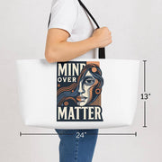 Tote bag with 'Mind Over Matter' design held by a person, with dimensions displayed.