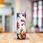 Tumbler with floral design on a wooden table with a blurred background