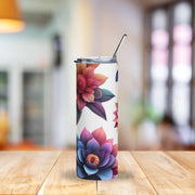 Tumbler with floral design on a wooden table with a blurred background