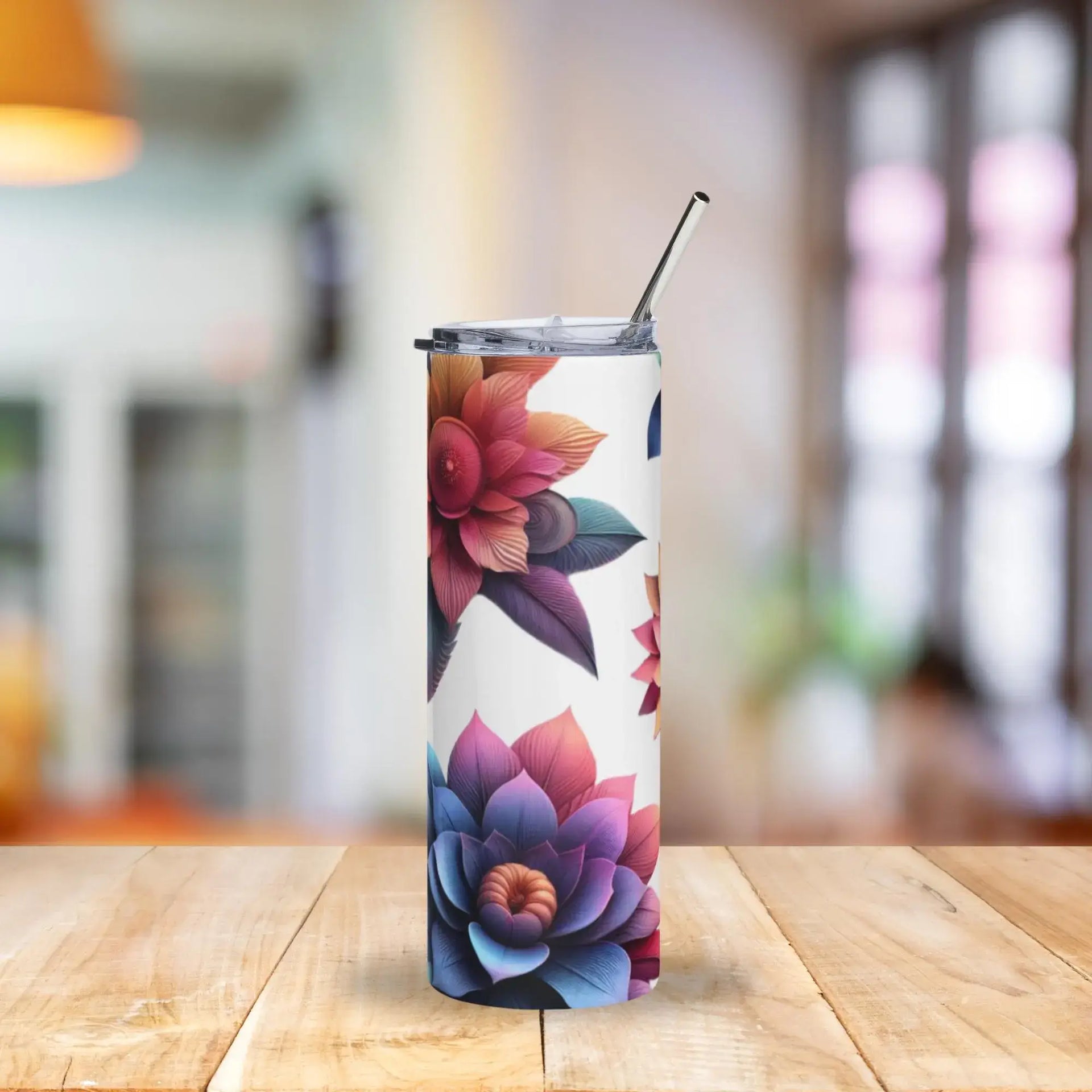 Tumbler with floral design on a wooden table with a blurred background