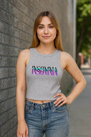 Woman wearing a gray tank top with 'INSOMNIA' print against a brick wall.