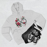 Gray hoodie with floral design, black jeans, and black sneakers on a light gray background