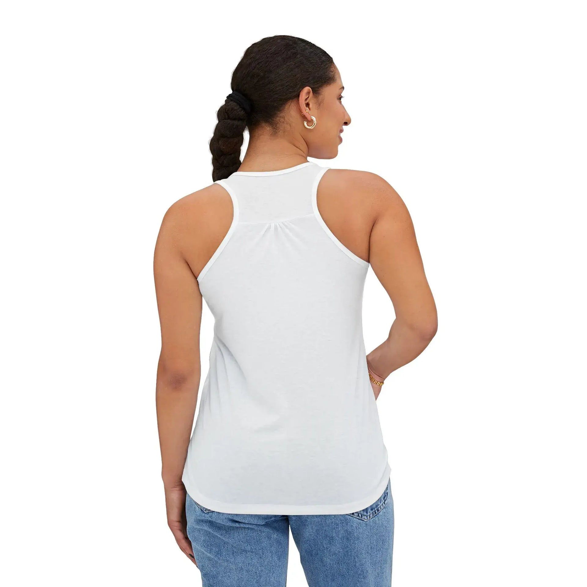 Woman wearing a white tank top and blue jeans on a white background