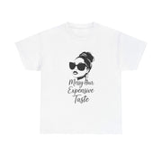 White t-shirt with a graphic of a woman with messy hair and sunglasses and text 'Messy Hair Expensive Taste' on a white background.