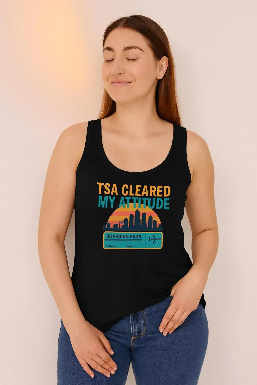 Woman wearing a black tank top with 'TSA Cleared My Attitude' design against a plain background