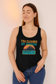 Woman wearing a black tank top with 'TSA Cleared My Attitude' design against a plain background
