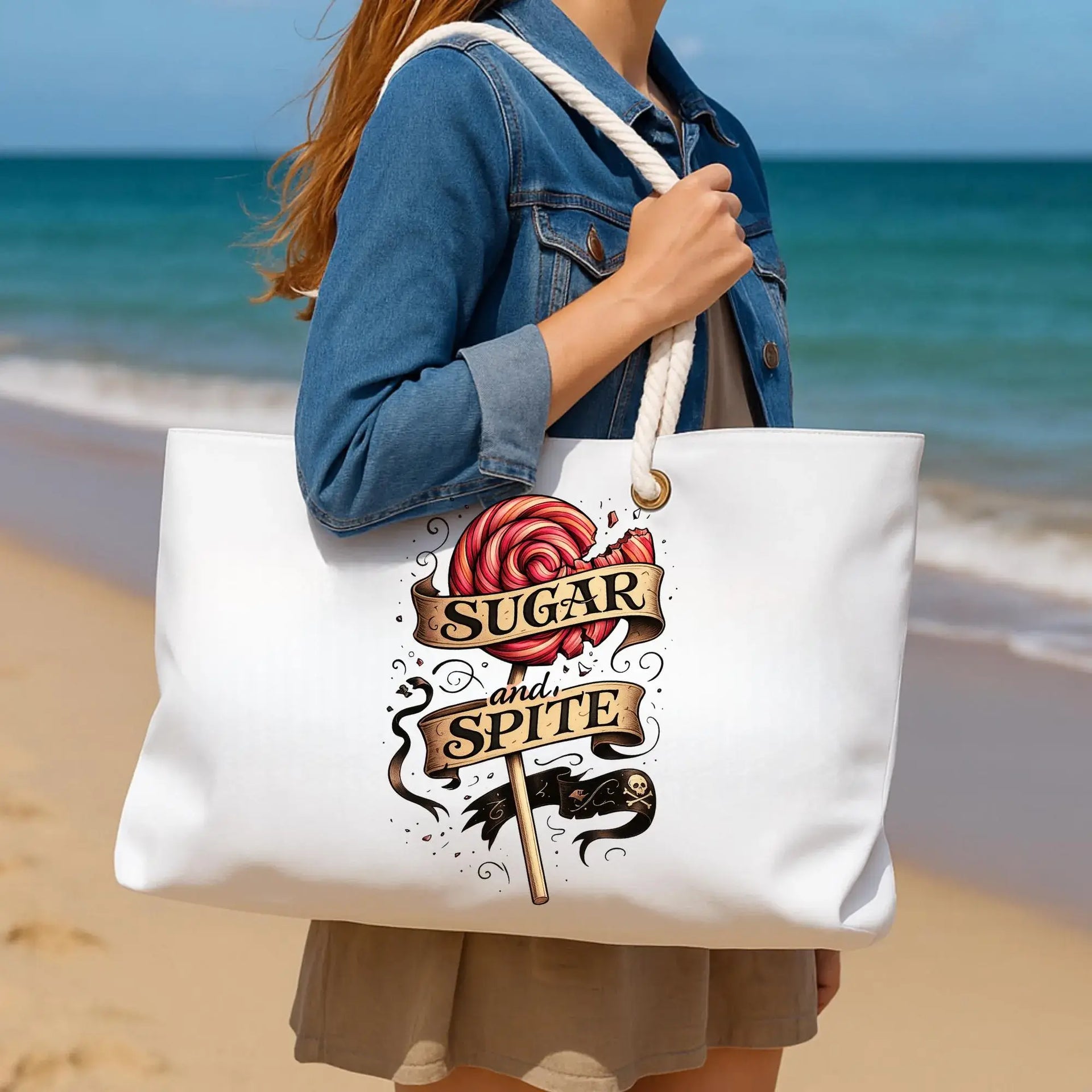 Person holding a tote bag with a rose design and text on a beach
