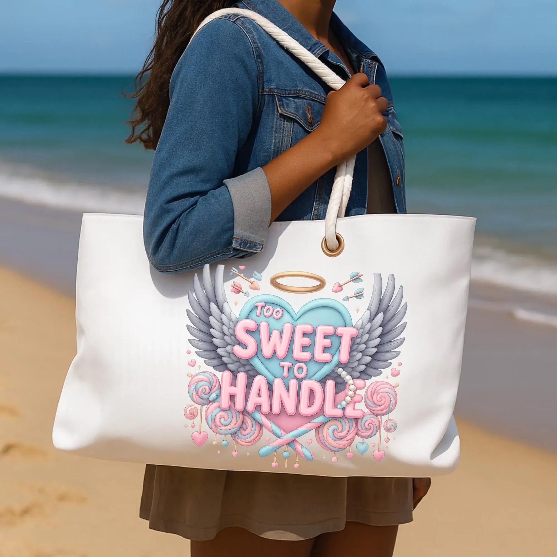 Person holding a tote bag with a design on a beach