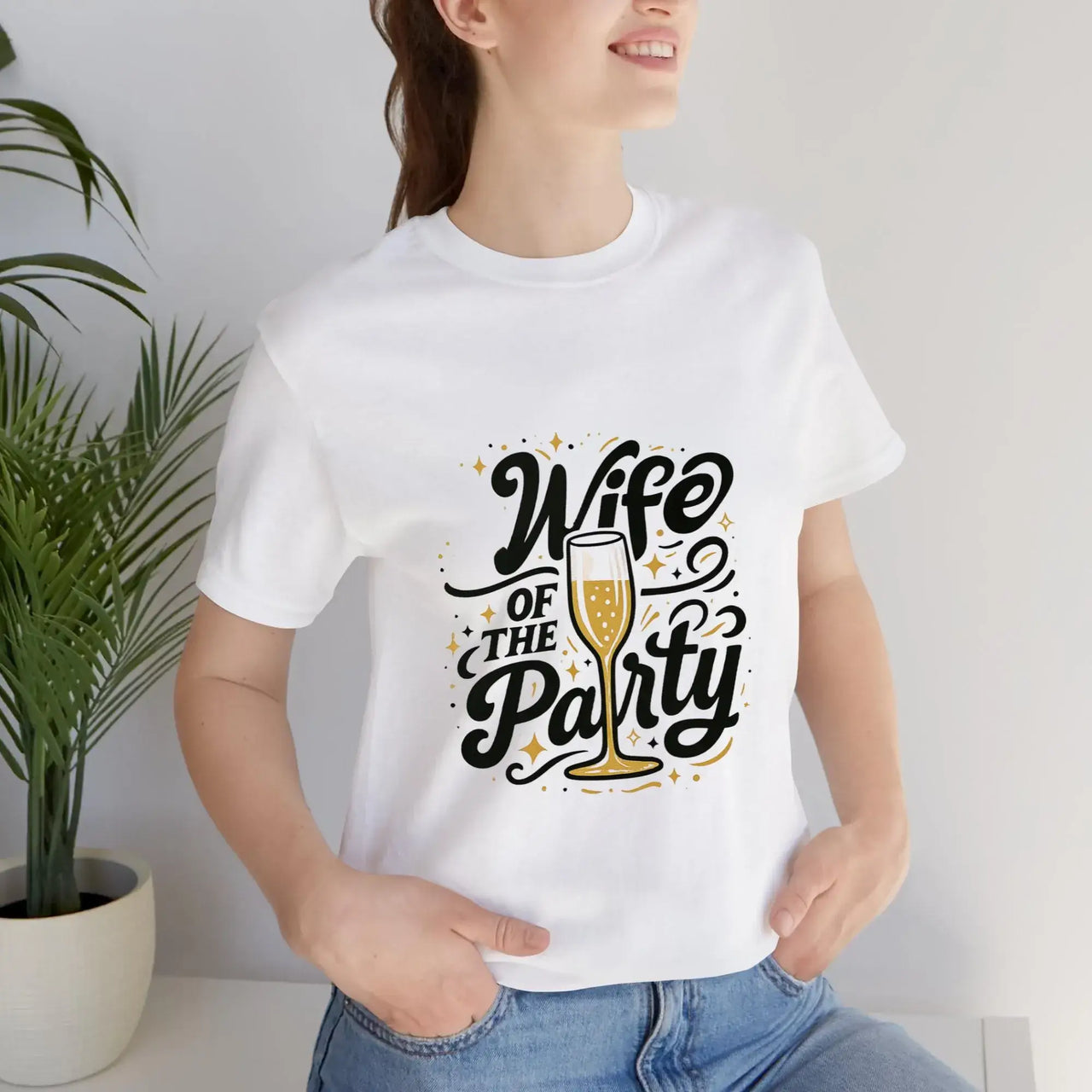 Person wearing a white t-shirt with 'Wife of the Party' text and champagne glass graphic.