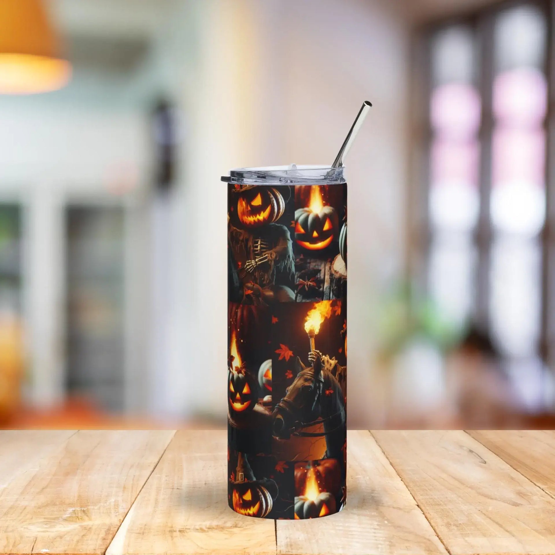 Tumbler with Halloween design featuring pumpkins and ghosts on a wooden table.