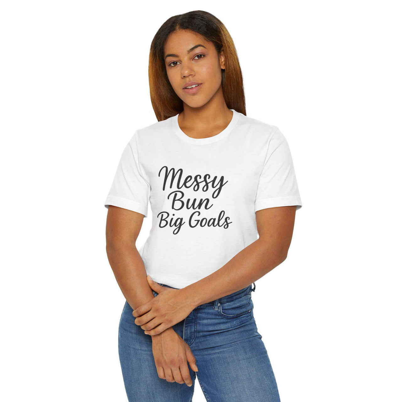 Woman wearing a white t-shirt with 'Messy Bun Big Goals' text on a white background