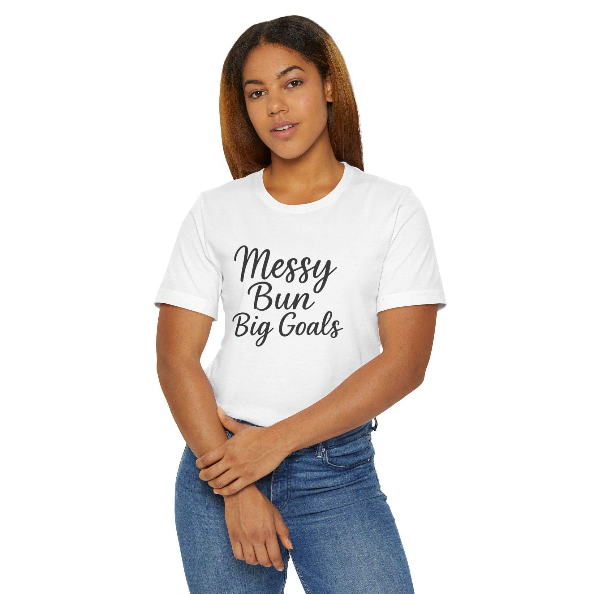Woman wearing a white t-shirt with 'Messy Bun Big Goals' text on a white background