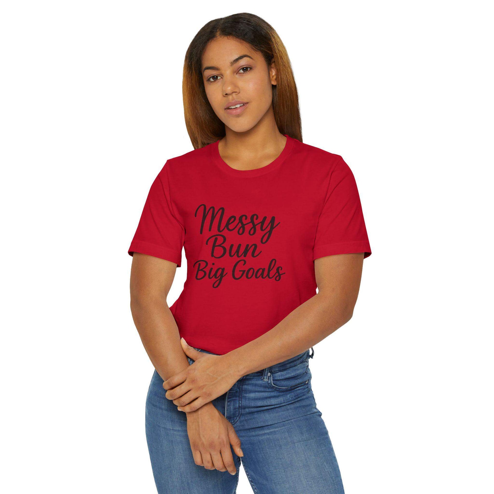 Woman wearing a red t-shirt with 'Messy Bun Big Goals' text on a white background