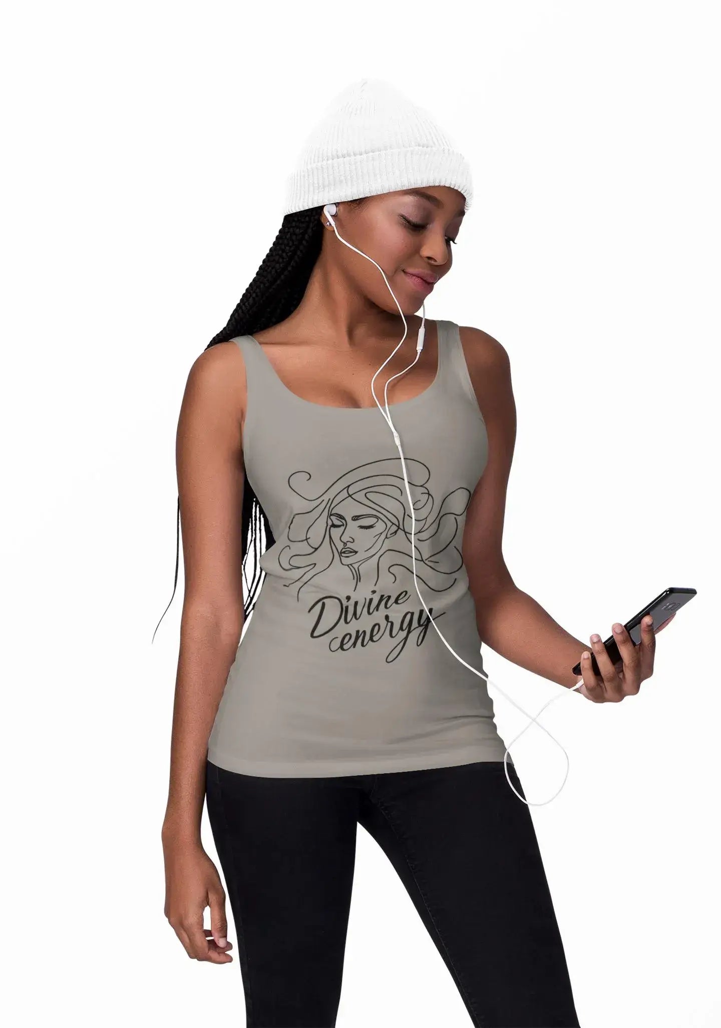 Woman wearing a tank top with 'Divine energy' text and listening to music on headphones.