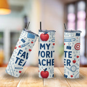 Three tumblers with educational-themed designs on a wooden surface.