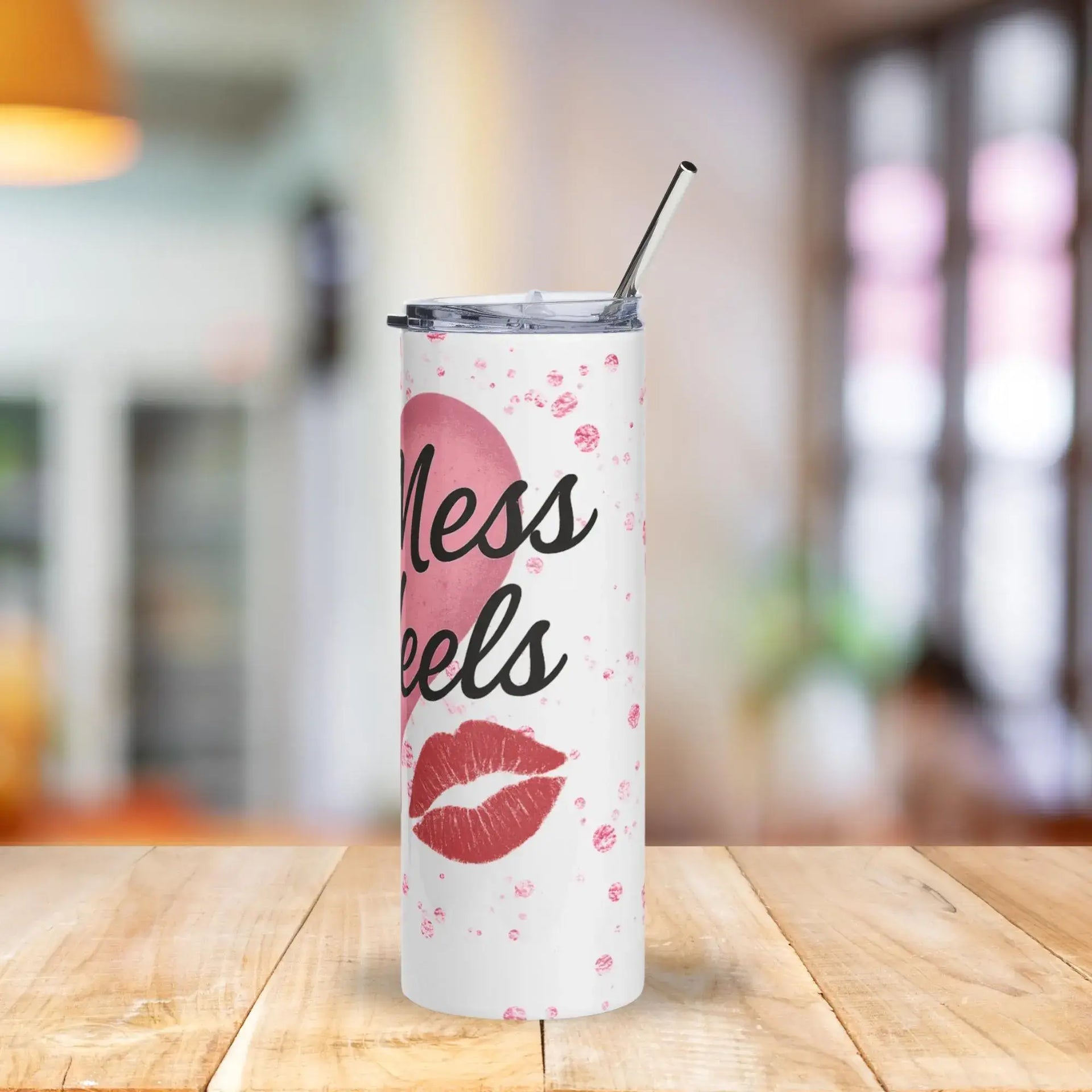 Tumbler with 'less heels' design on a wooden table