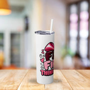 White tumbler with colorful design on a wooden table with a blurred background