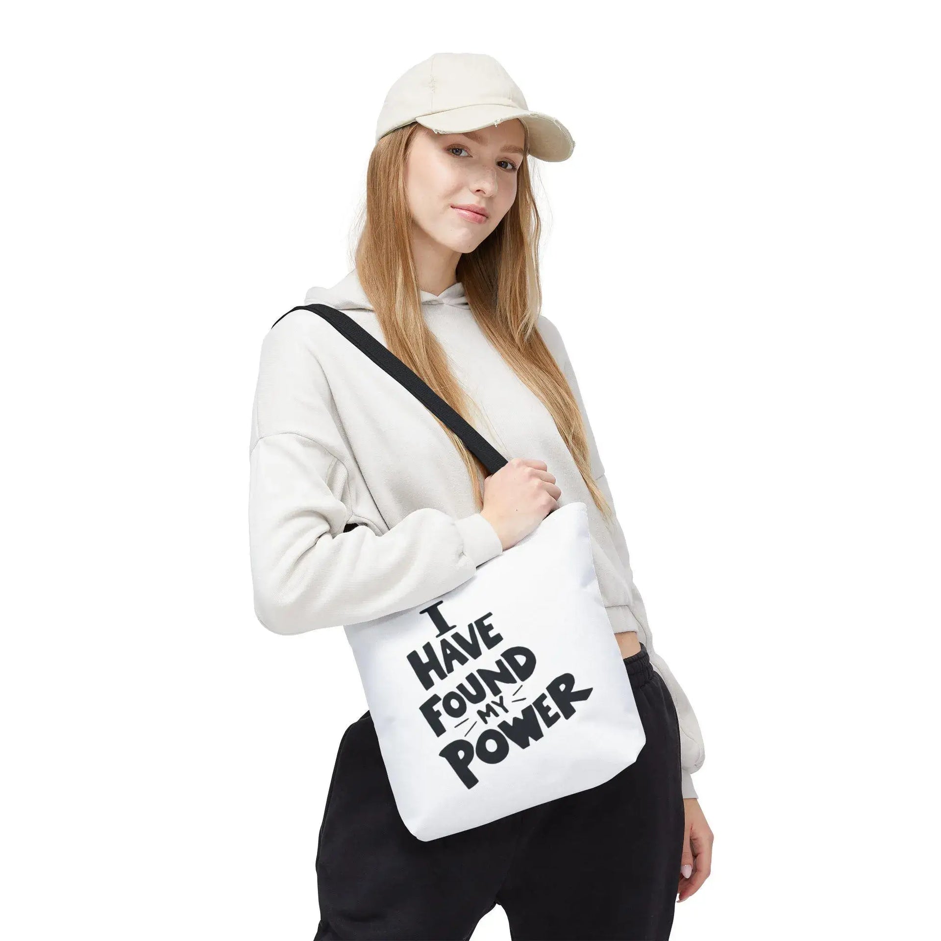 Person holding a white bag with 'I Have Found My Power' text on a white background
