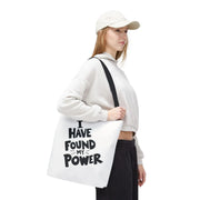Person holding a tote bag with 'I have found my power' text on a white background