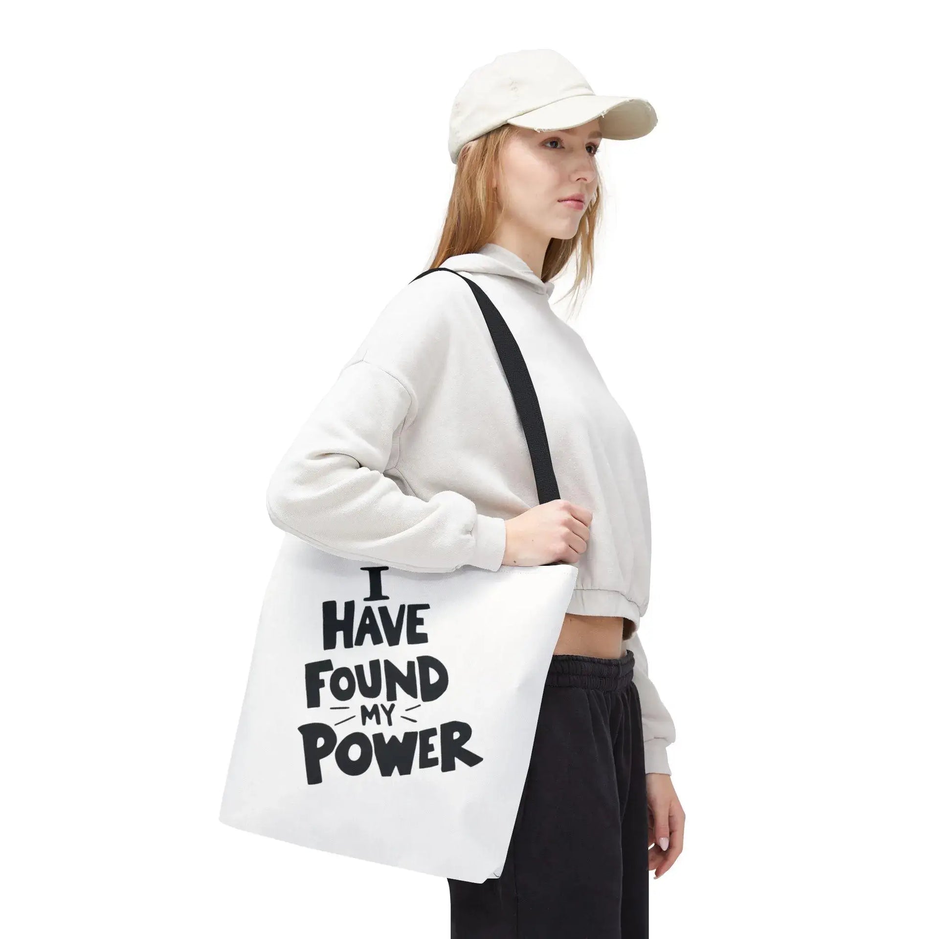 Person holding a tote bag with 'I have found my power' text on a white background