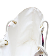 White drawstring bag with floral patterns on a white background