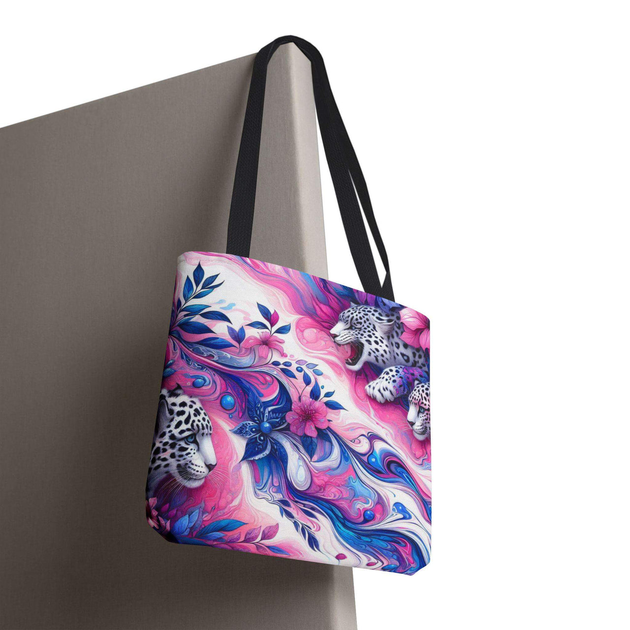 Tote bag with a colorful design featuring leopards and floral elements on a white background.