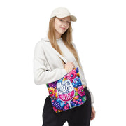 Person holding a colorful bag with floral design and text on a white background