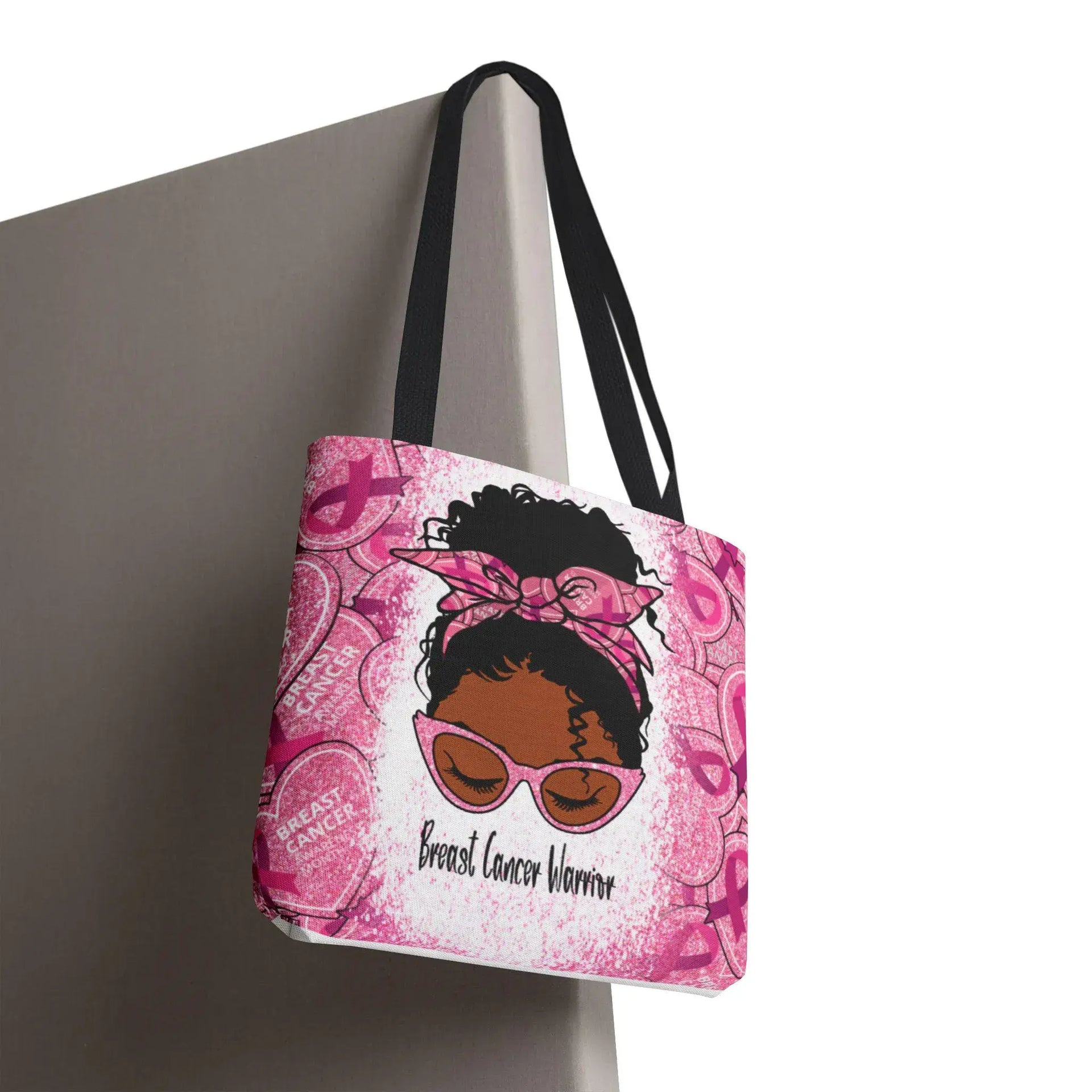 Tote bag with a design of a woman wearing sunglasses and a headband, with 'Breast Cancer Warrior' text, on a pink background.