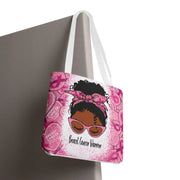 Pink tote bag with a graphic of a woman and 'Breast Cancer Warrior' text, hanging on a surface.