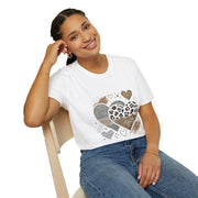 Woman wearing a white t-shirt with heart designs sitting on a chair.
