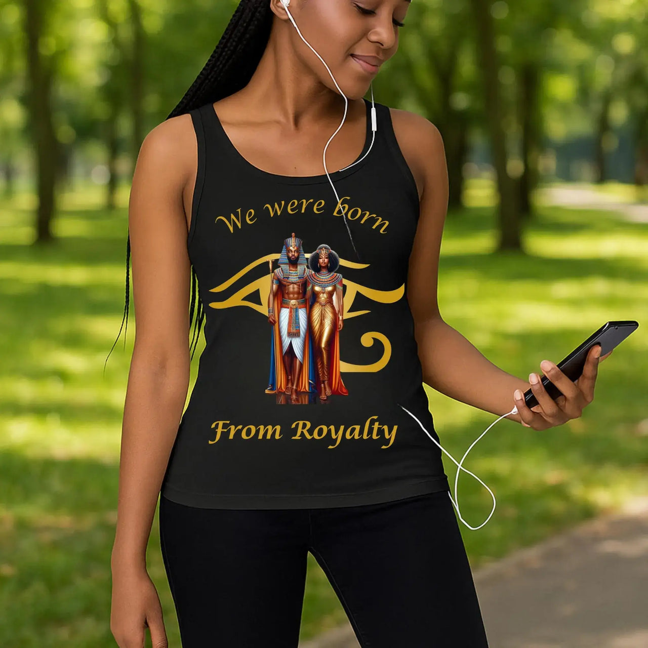 Woman wearing a tank top with 'We were born from royalty' design in a park.