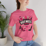 Person wearing a pink t-shirt with 'Hot Mess' graphic design.