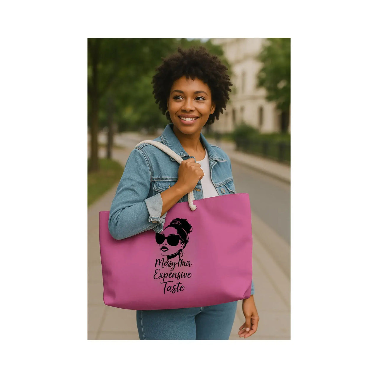 Woman holding a pink tote bag with a graphic design and text.